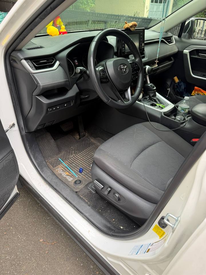 Car interior with dirt and crumbs before a mobile interior cleaning in Bergen County, NJ